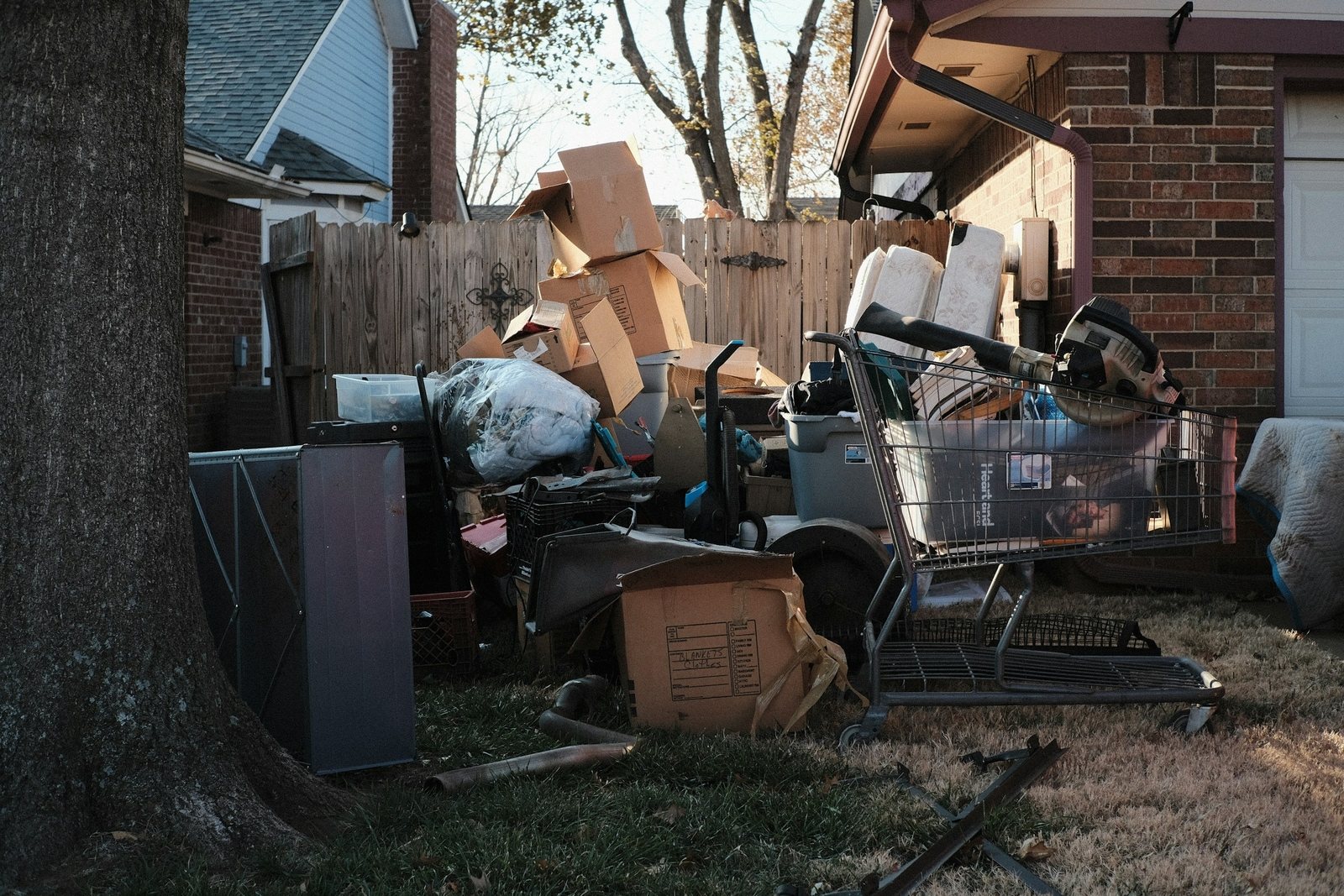 Backyard pile of household junk and clutter staged for removal